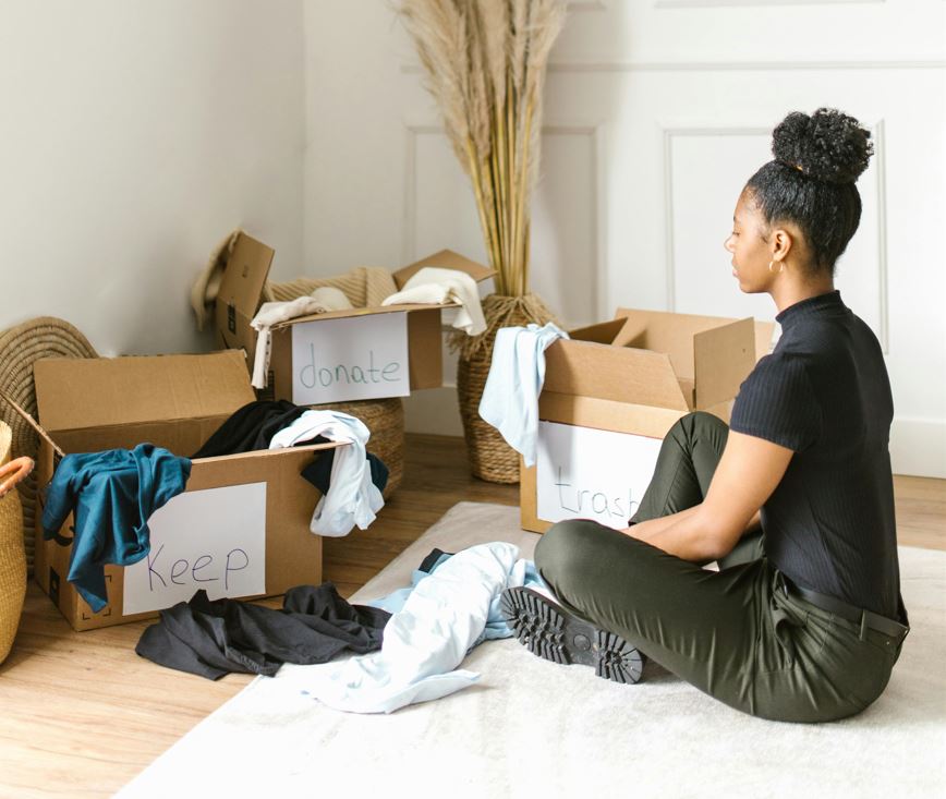 Woman Sitting on a Rug Sorting Clothes