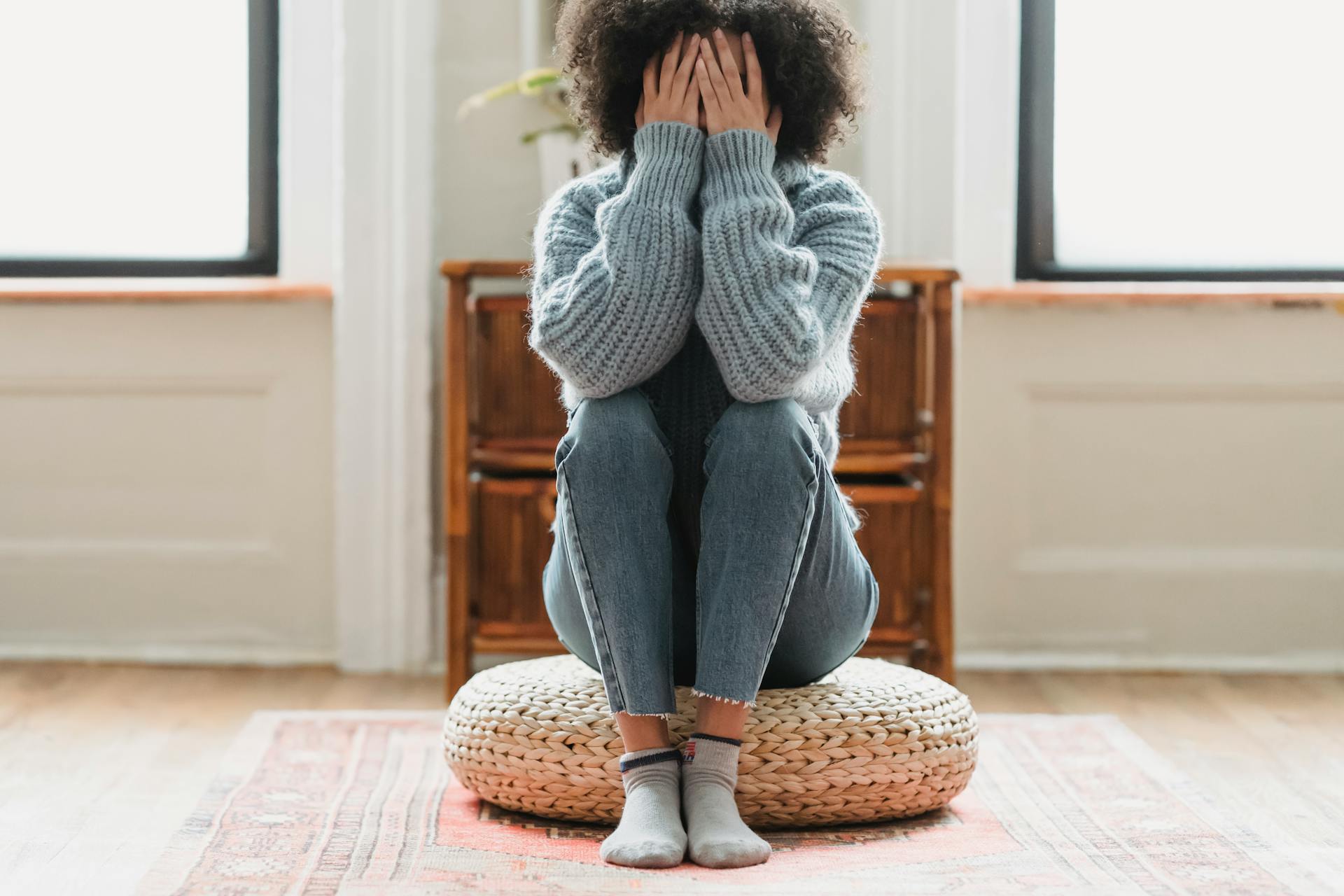 Faceless unhappy woman covering face